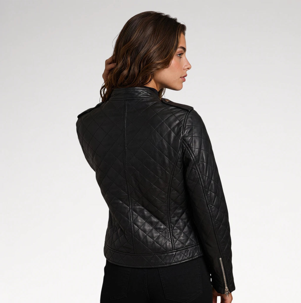 A woman shown from the back wearing a black quilted leather jacket against a plain light gray studio background.