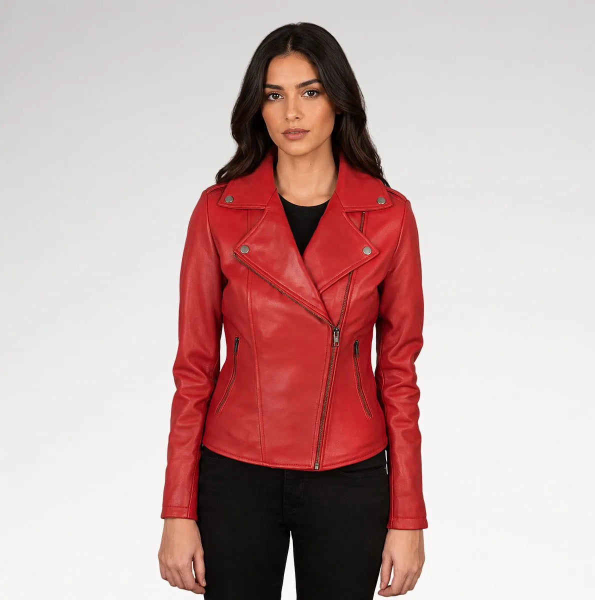 A woman modeling a red faux leather moto jacket with silver-tone hardware, worn over a black top and black pants, against a light gray studio background. Main image