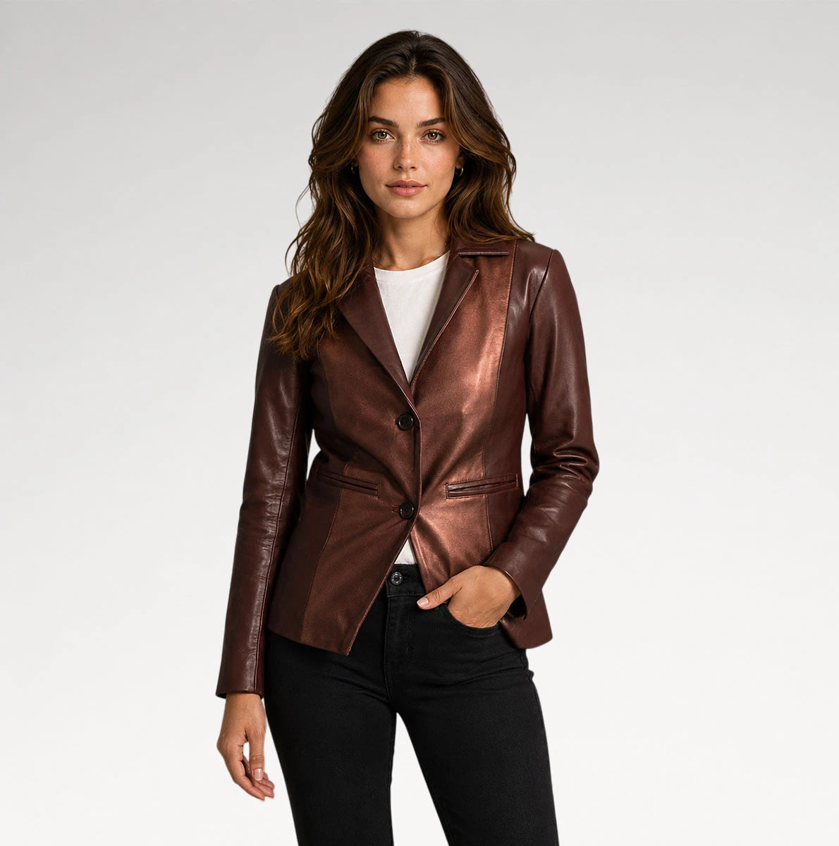 A woman modeling a metallic bronze-brown leather blazer over a white t-shirt and black jeans, photographed against a seamless light gray studio background. Main image