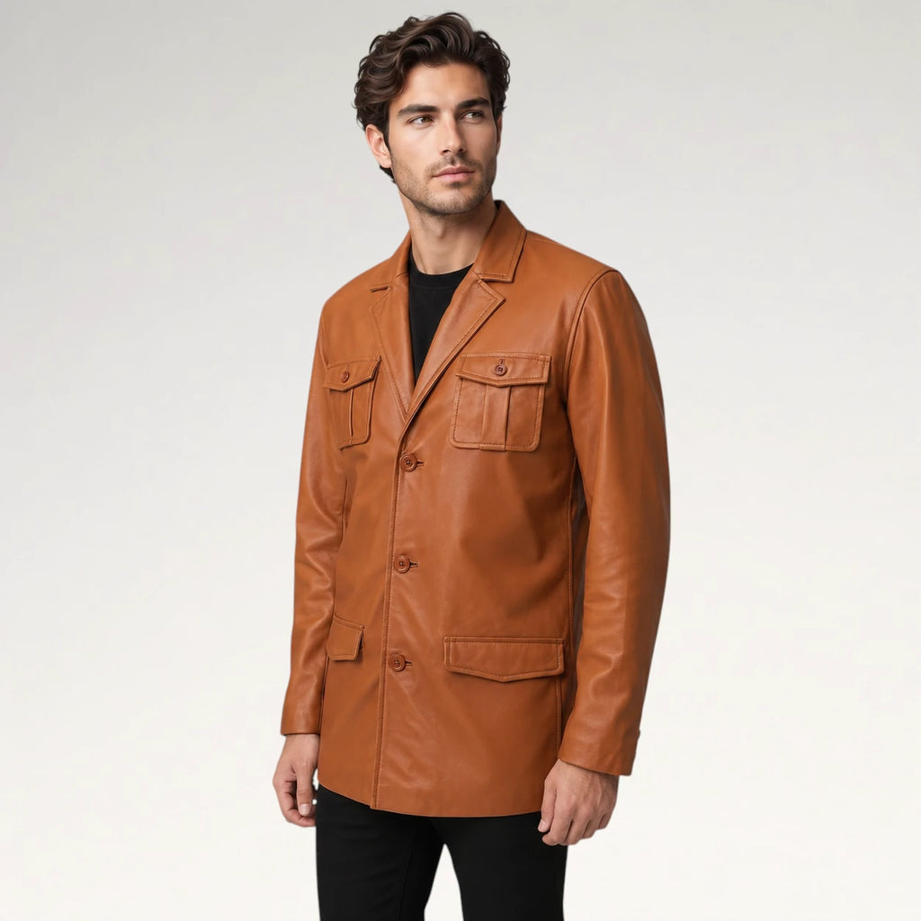 A man wearing a tan leather blazer-style jacket with flap chest pockets and a front button closure, photographed against a clean light gray studio background.