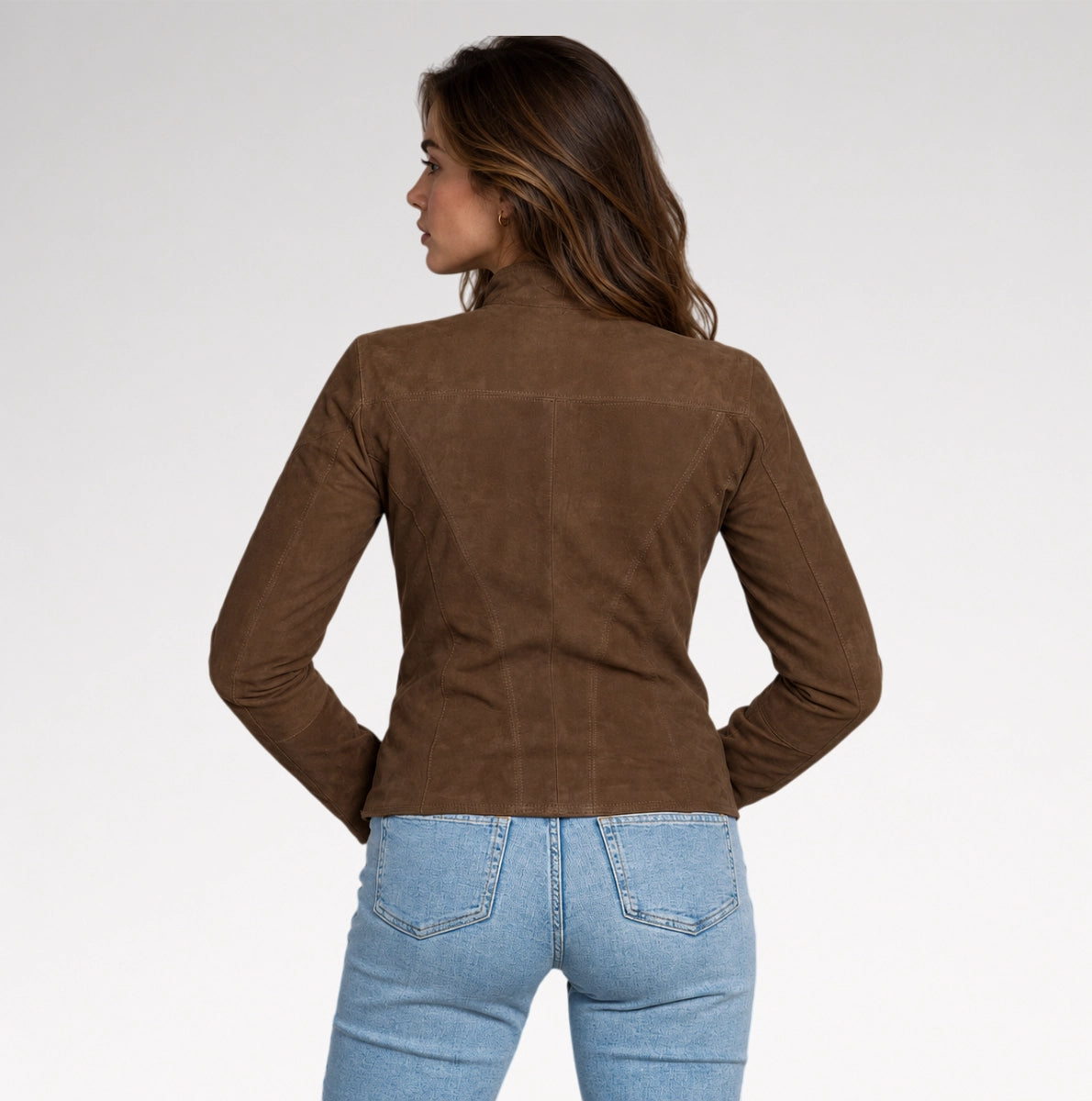 A girl is wearing dark brown suede leather jacket with a back pose on grey background.
