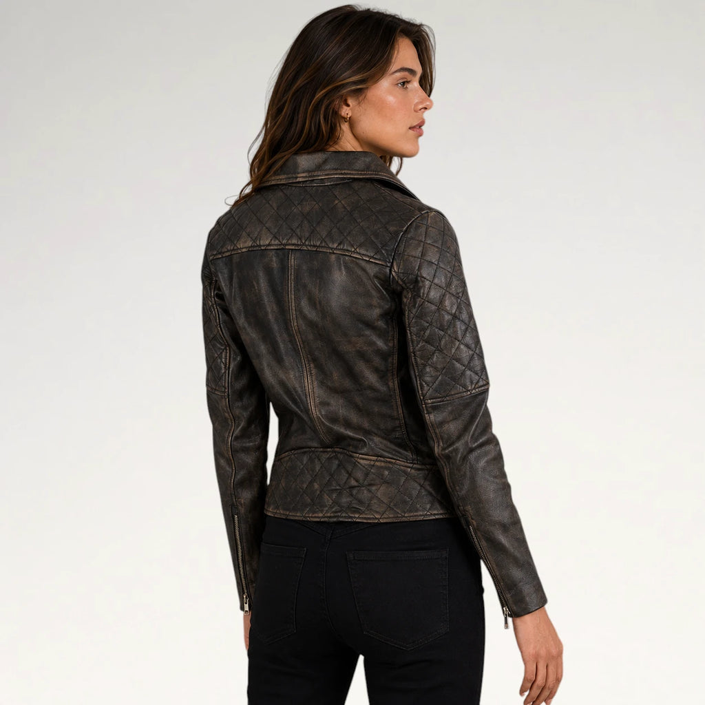 A woman wearing a dark brown quilted leather jacket, shown from a three-quarters back view against a light gray studio background.