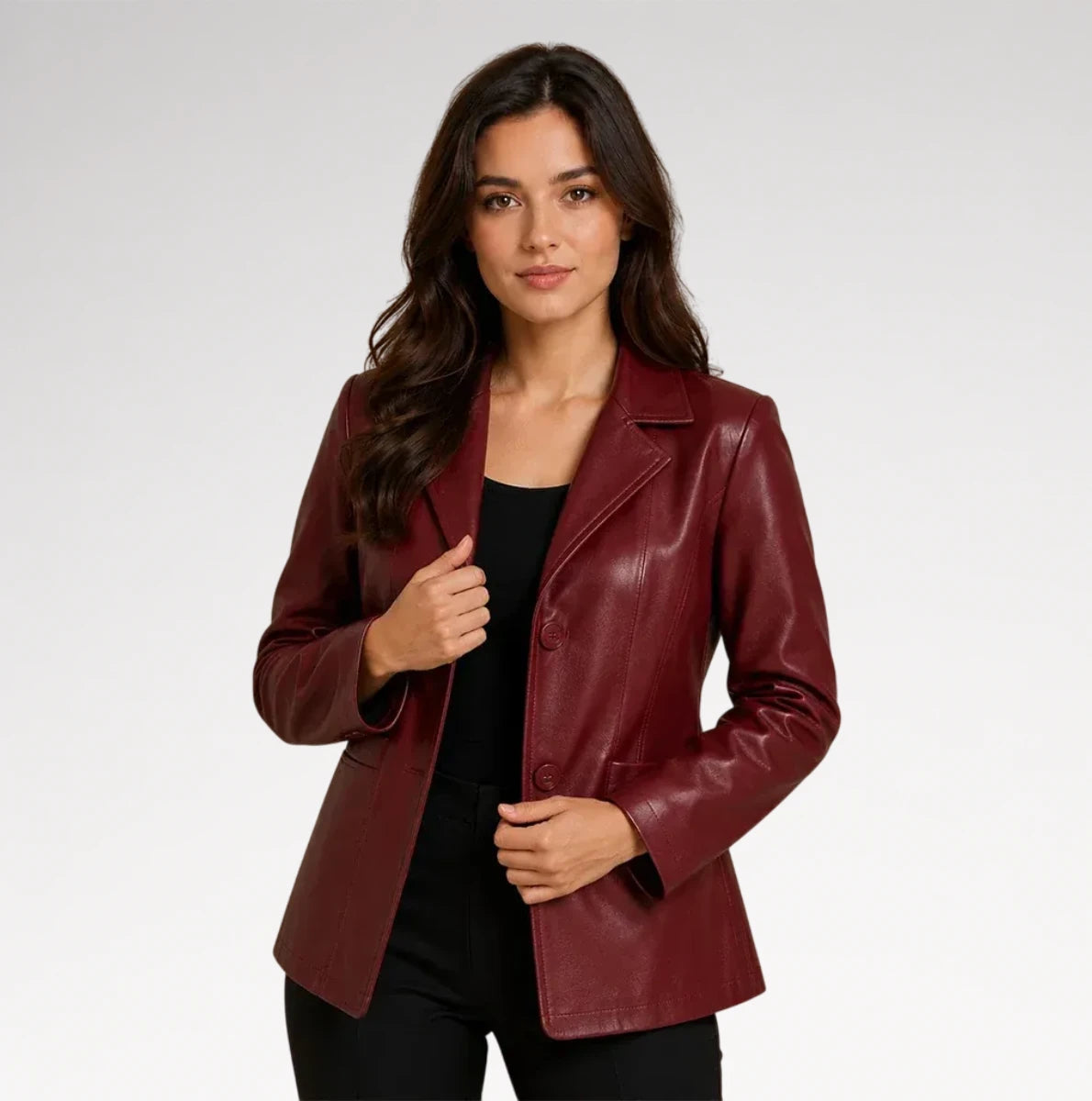 A woman modeling a burgundy faux-leather blazer over a black top and black pants, photographed against a light gray studio background. Main image