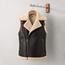 Black leather vest with beige shearling collar and lining on a wooden hanger against a gray background.