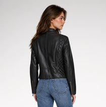 A model is wearing black quilted leather jacket for women in grey background