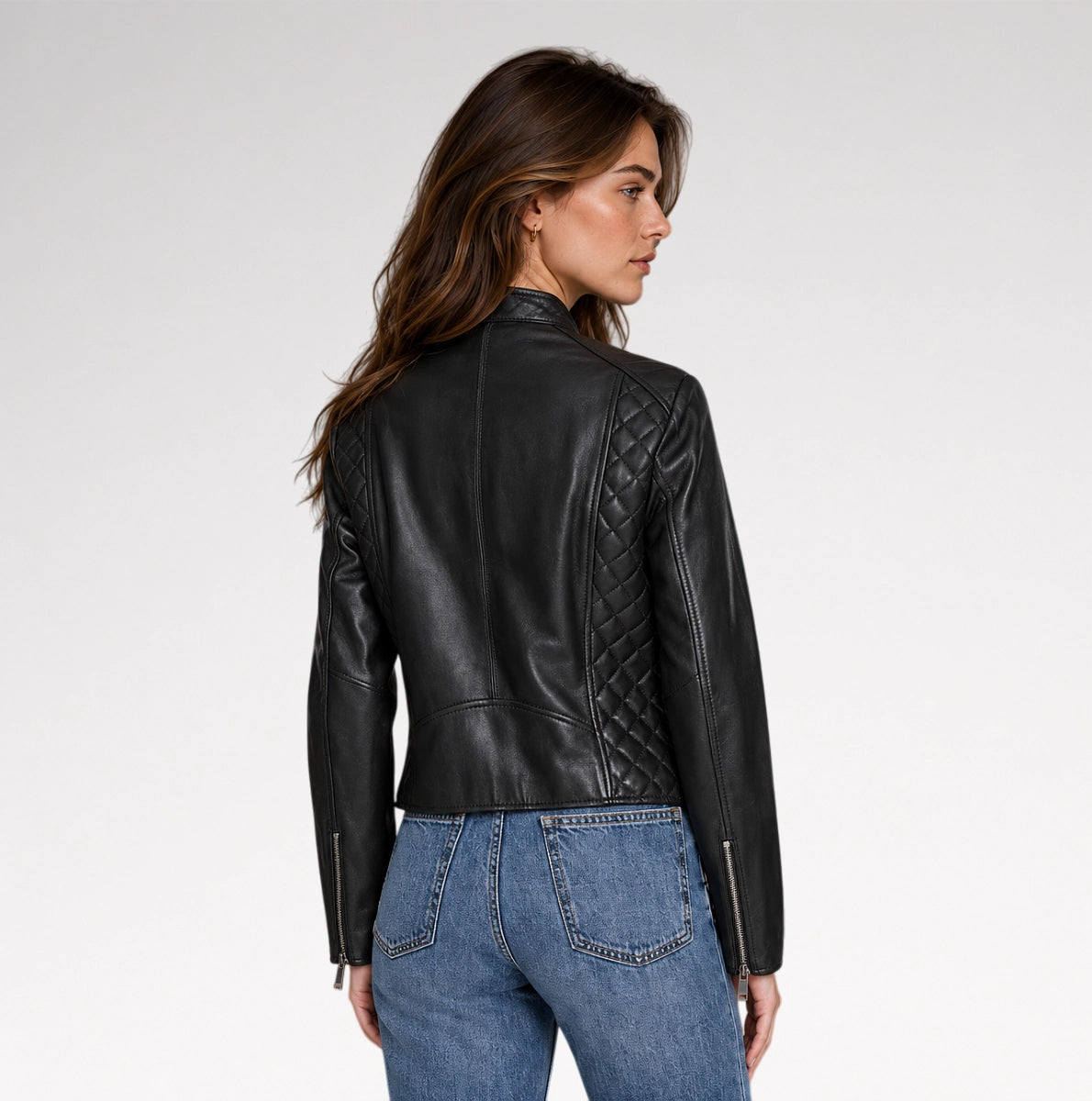 A model is wearing black quilted leather jacket for women in grey background