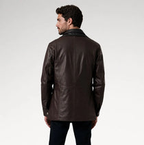 A man wearing a dark brown leather jacket, shown from the back against a light gray studio background.